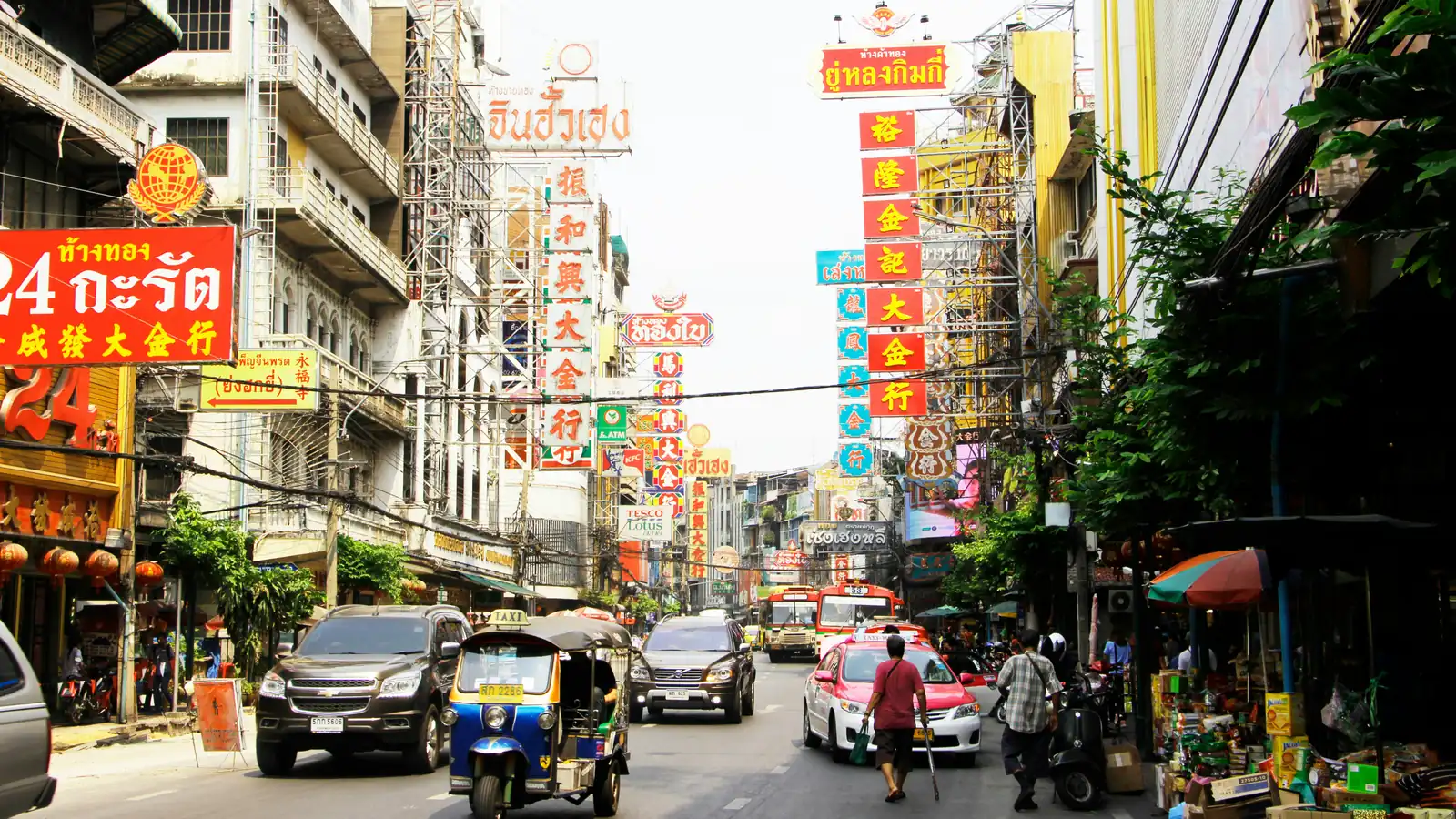 Yaowarat Road in Bangkok’s Chinatown, with a tuk-tuk in the traffic