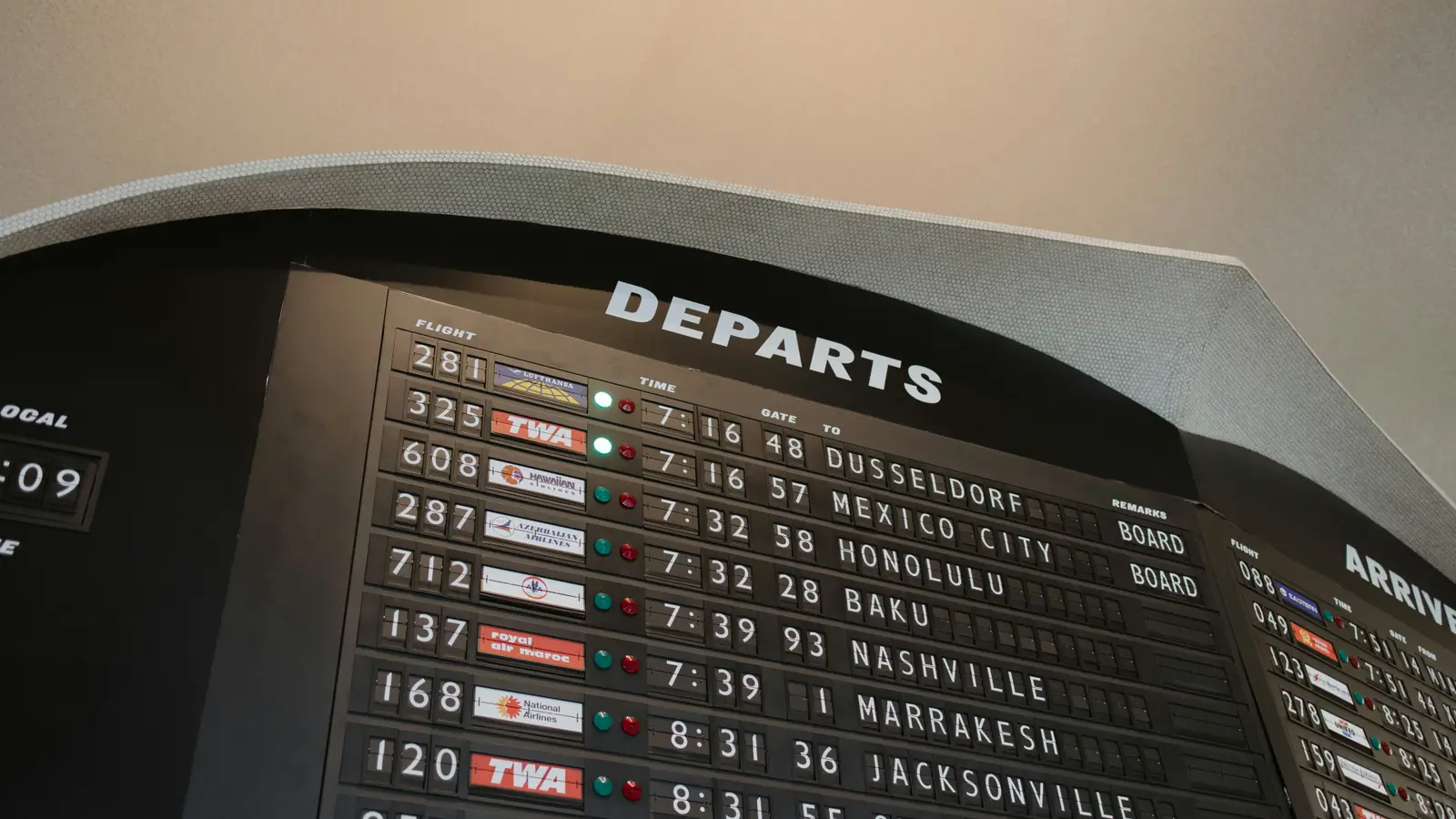 An airport departures board listing flights