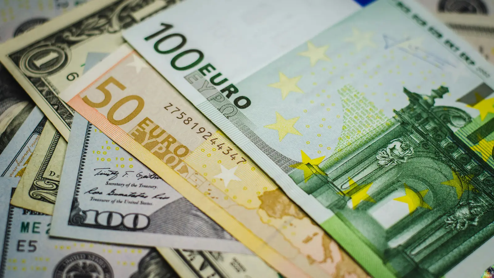 Euro and US dollar banknotes lying together