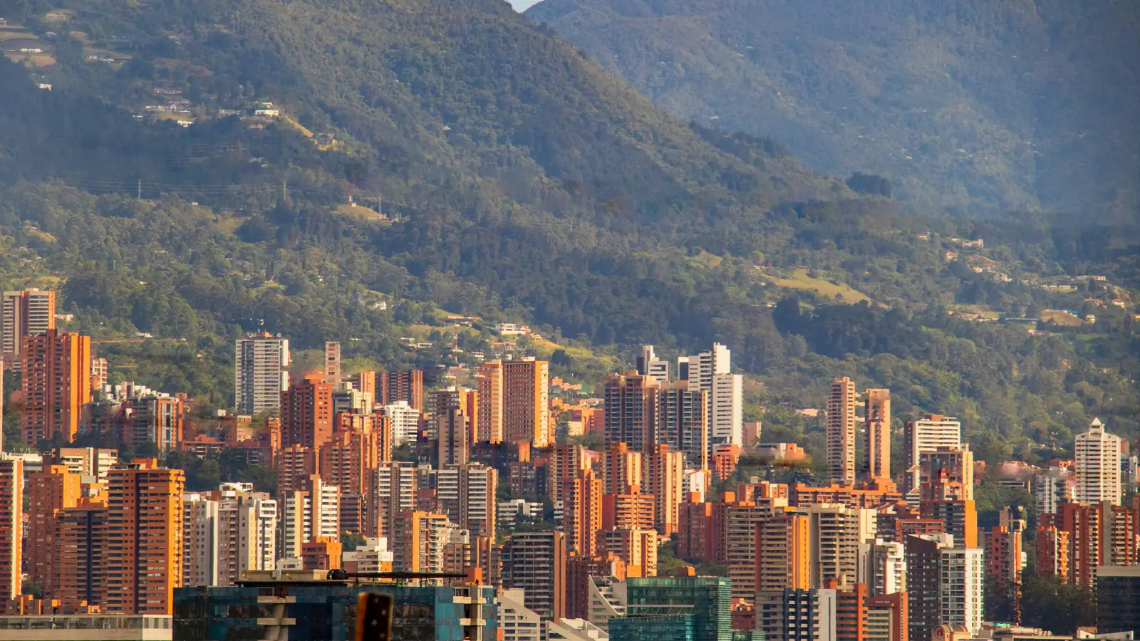 Brick apartment towers of Medellín against the green hills of the Aburrá Valley