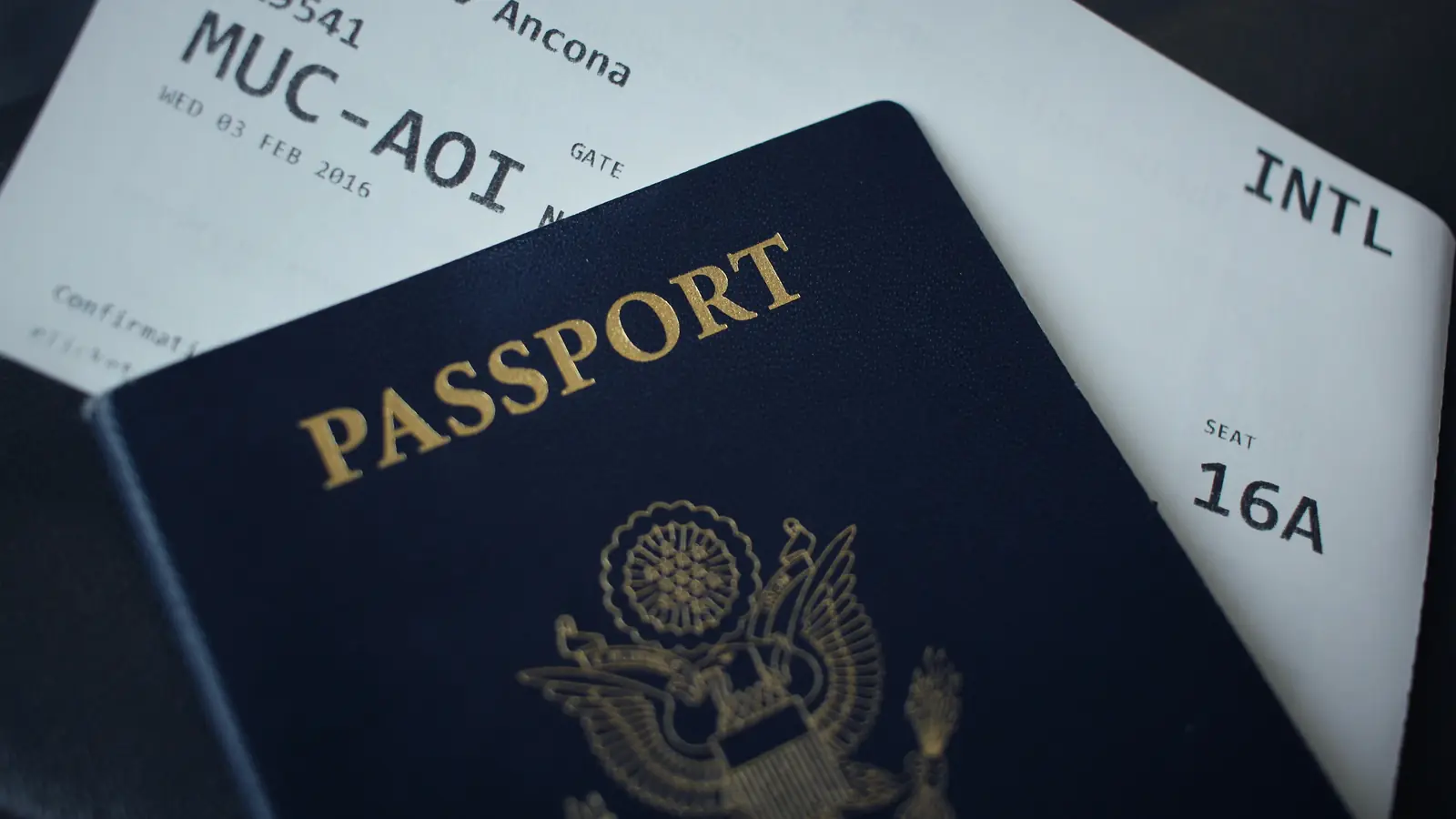 A passport lying on a boarding pass