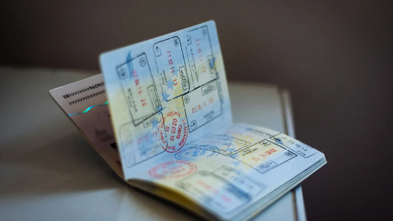 An open passport with entry and exit stamps